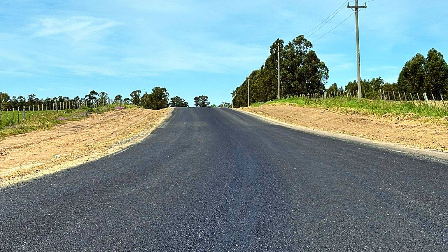 Camino rural con tratamiento bituminoso recién terminado por FABIDAL D&R
